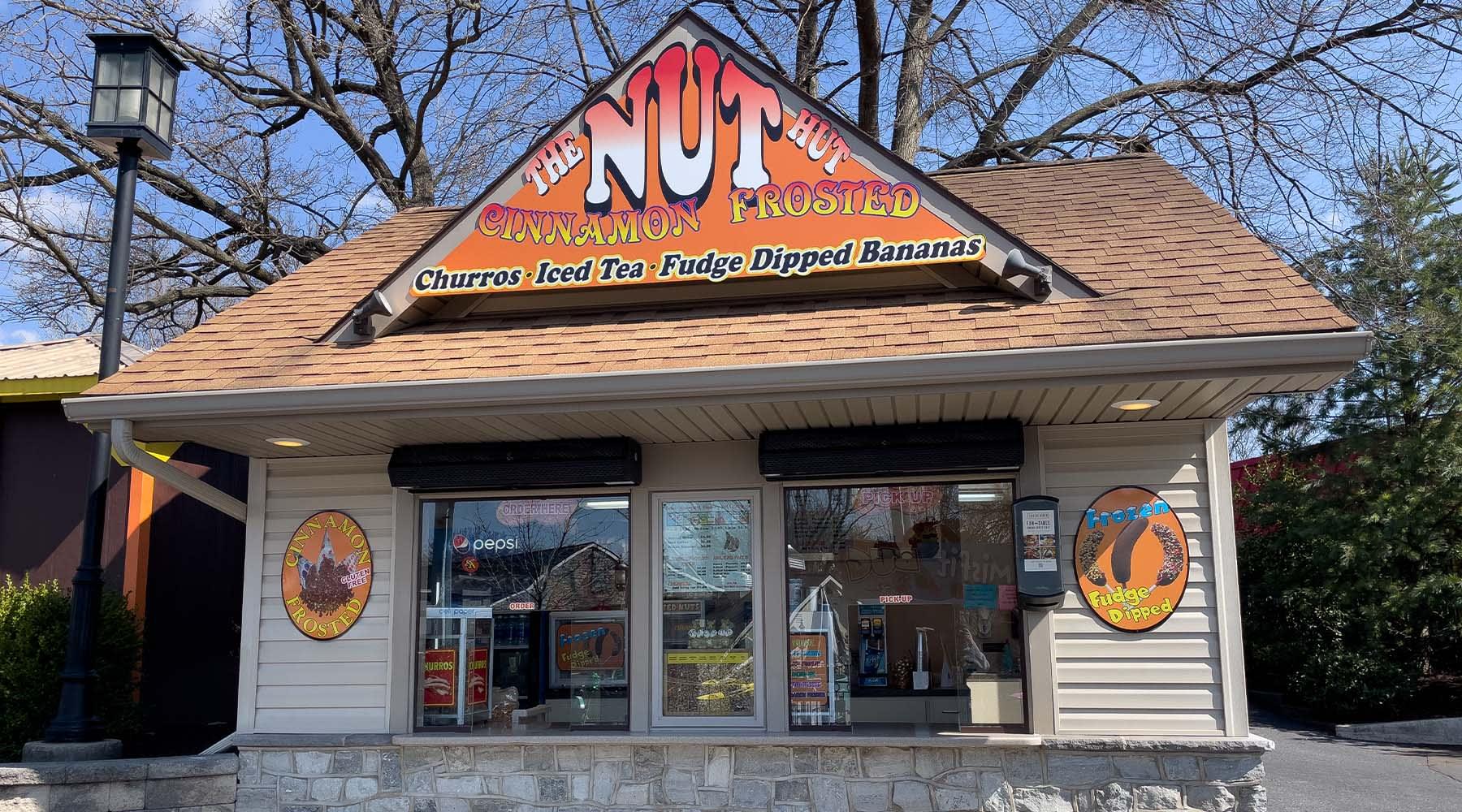 Building with Nut Hut sign on it and two people at the ordering windows