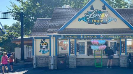 Yellow painted Lemon Drop building with order window and signage on the building.