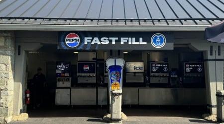 Inside of building with Pepsi machines and queue line