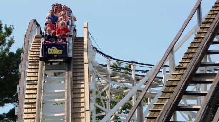 People riding The Comet Wooden Rollercoaster