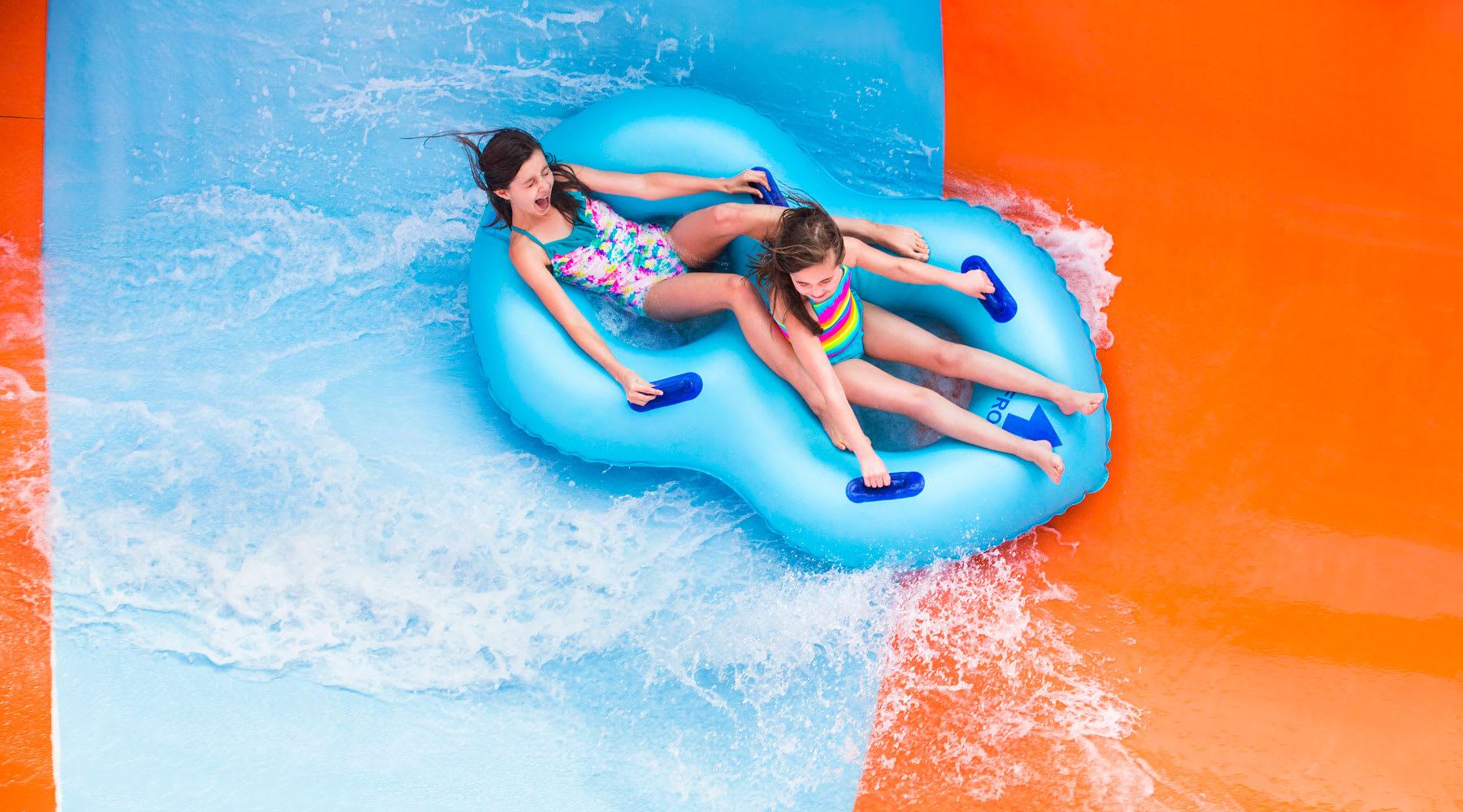 Girls riding Coastline Plunge Vortex water slide