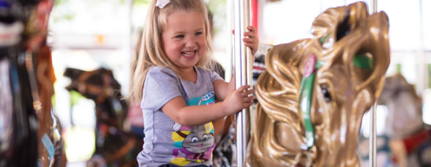 Girl smiling on the Carrousel at Hersheypark